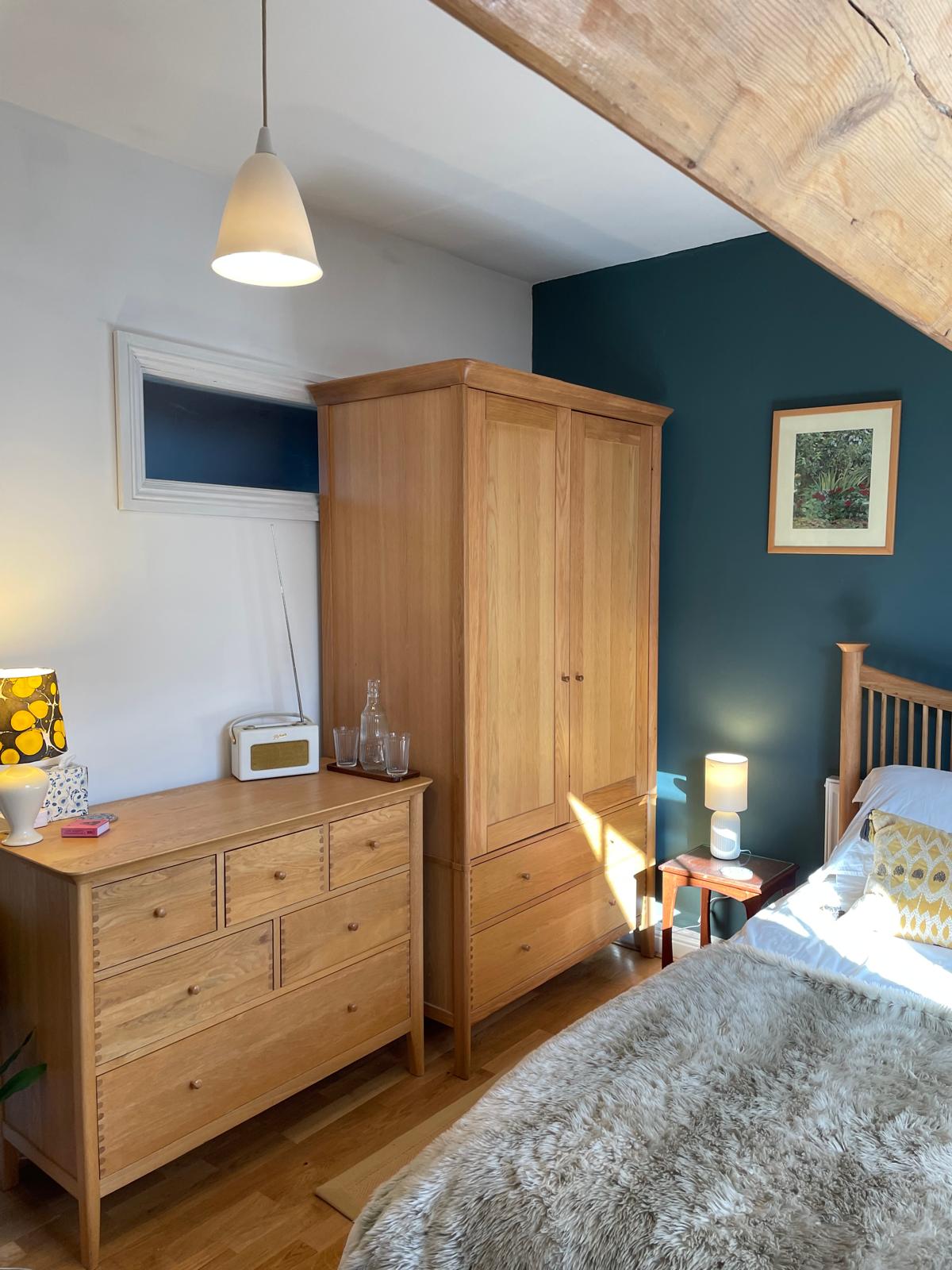Cozy luxury bedroom featuring wooden furniture, a soft rug, and warm lighting for a relaxing atmosphere